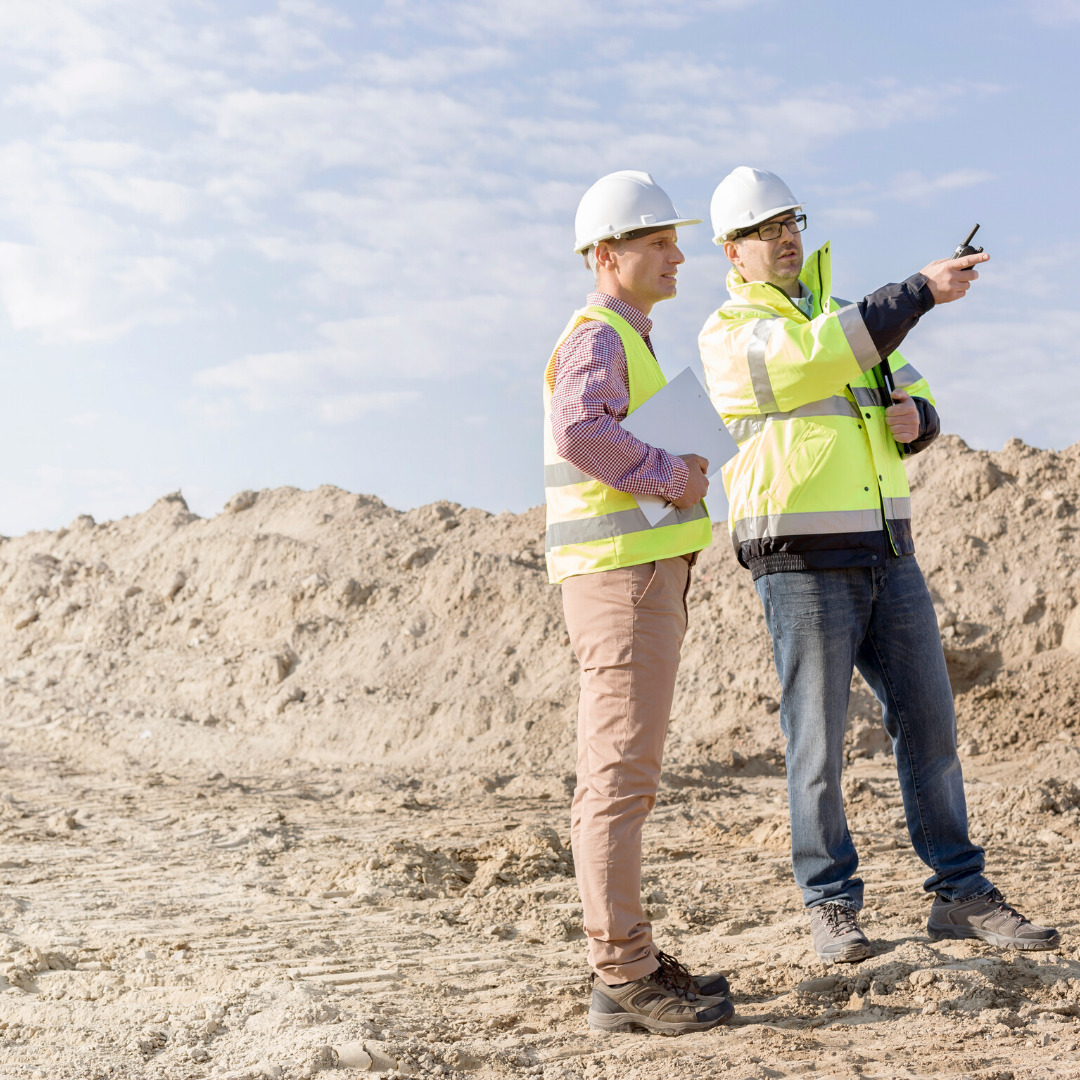 commercial plumbing and drain experts discuss the site of a new installation